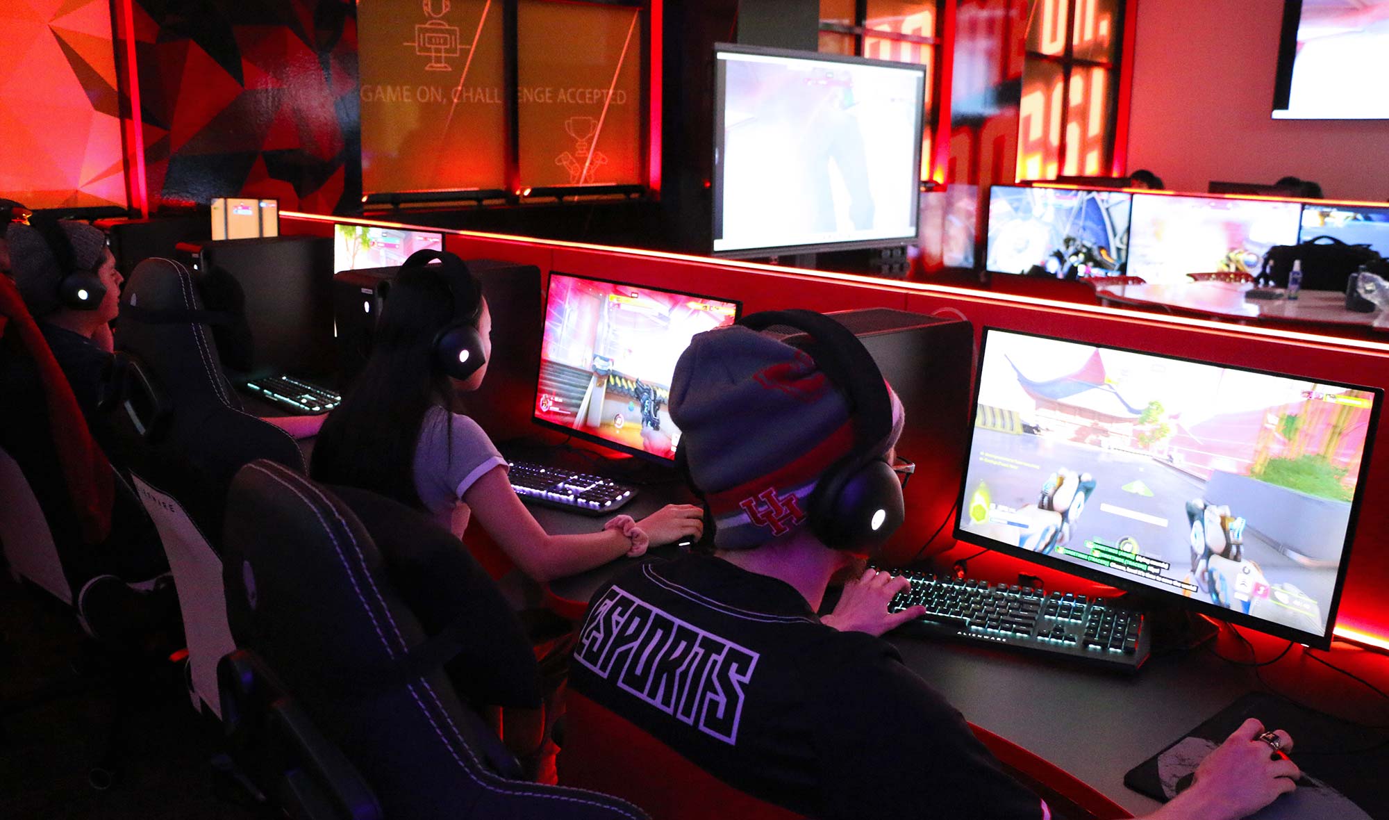 Members of the Coog Esports team sit at gaming stations playing.