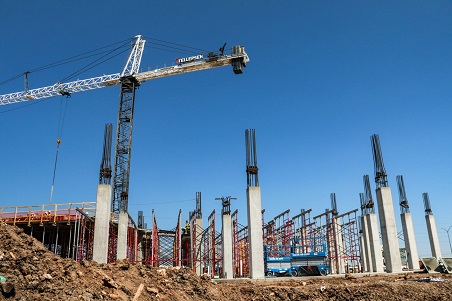 Construction site with cemement pillars and red scaffolding