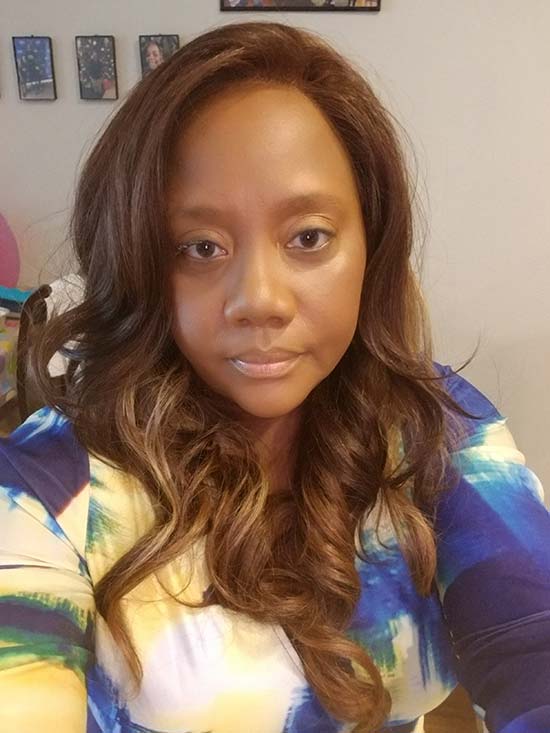 Portrait of a black woman with brown wavy hair