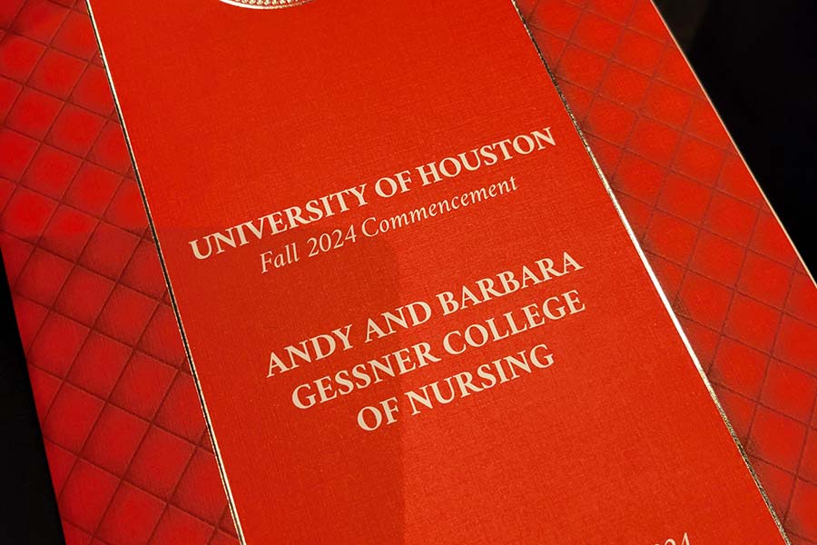 Red front cover of an event program. The words "University of Houston Fall 2024 Commencement. Andy and Barbara Gessner College of Nursing" appear on the cover in gold letters.