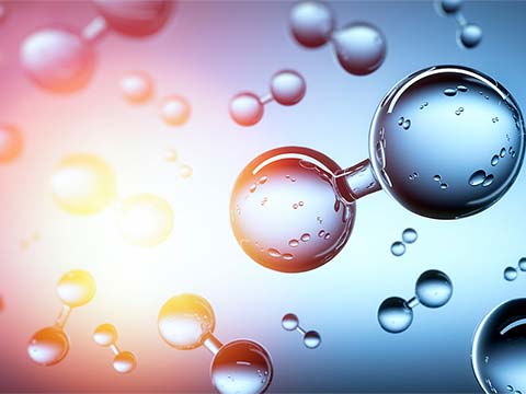 Droplets of water float in pairs connected by a bar of water to appear like molecules.