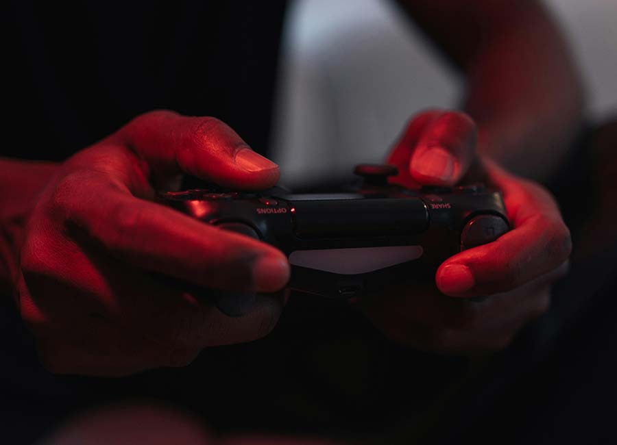 Close up of hands holding a video game controller